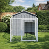 Steel dog kennel and run placed on a lawn in a garden with fencing and hedges behind