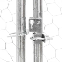 Close-up of the lockable metal catch on the hexagonal mesh dog run door