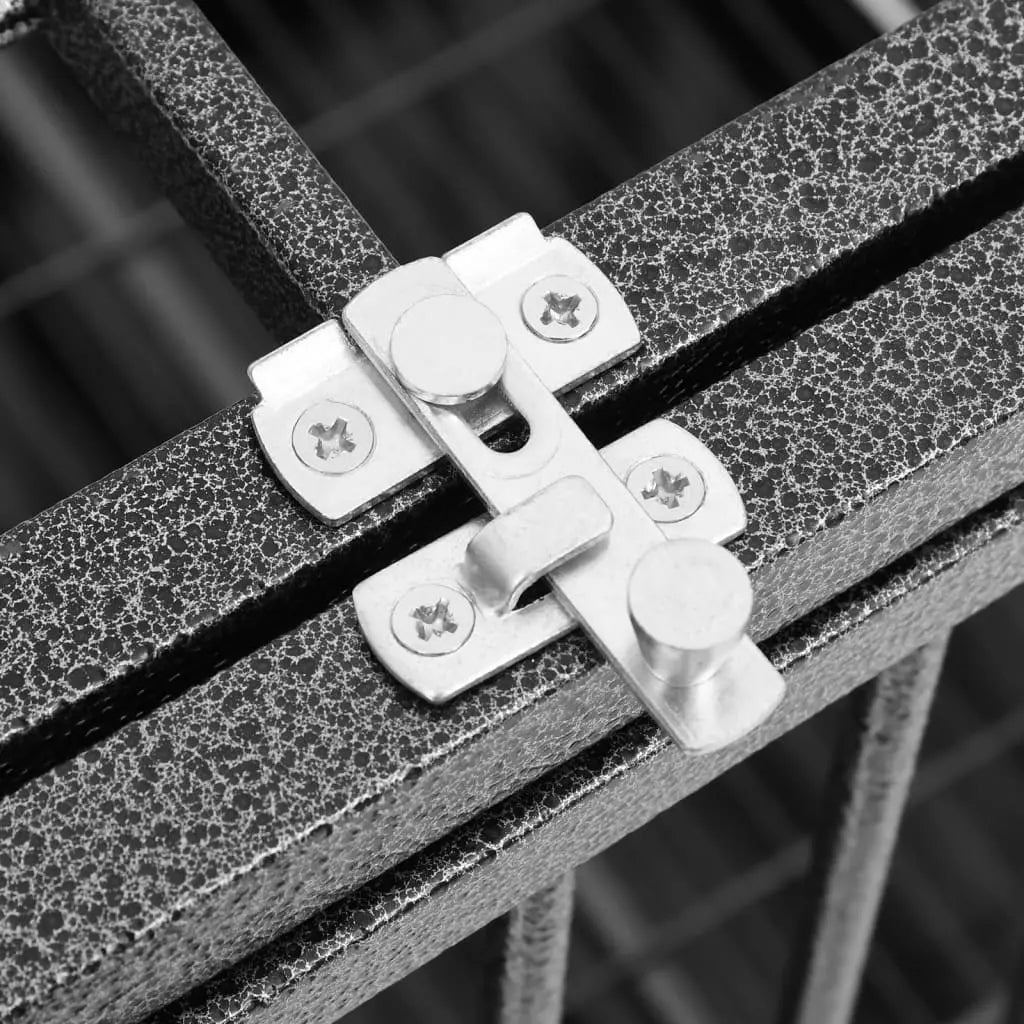 Close-up of the two metal latches on the hinged door of the roofed steel dog crate