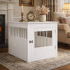 White dog crate furniture used as an end table in a living room with decorative objects on top