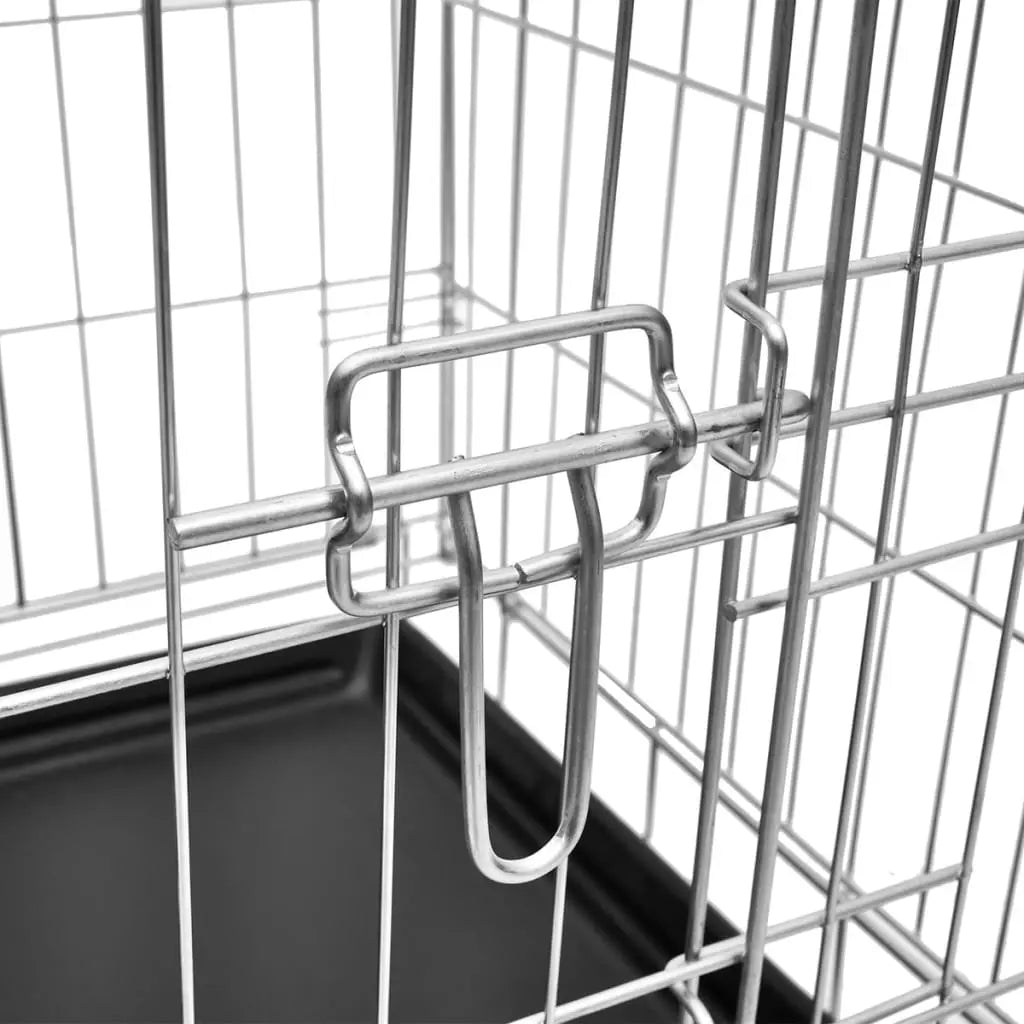 Close-up of the sliding metal door latch on the galvanised steel dog crate