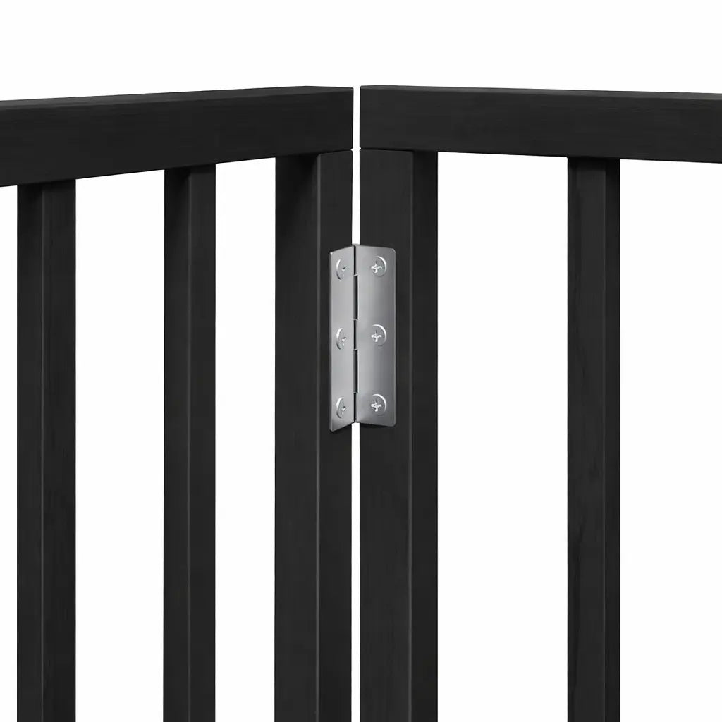 Black six-panel dog gate with stabilising feet fitted, dividing an indoor room
