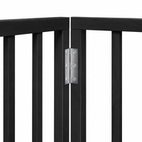 Black six-panel dog gate with stabilising feet fitted, dividing an indoor room