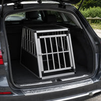 Single door aluminium dog crate positioned inside a car boot