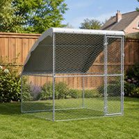 Heavy-duty galvanized outdoor dog kennel with roof cover installed in residential garden