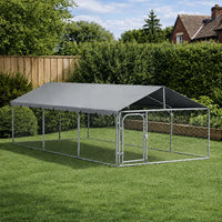 Four metre outdoor dog kennel with roof installed on a garden lawn, steel frame with mesh panels
